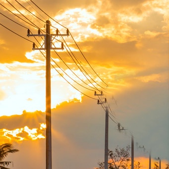 Telephone poles with a dramatic sky in the background..